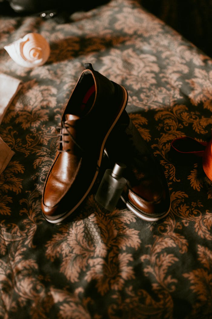 gallery-5 High-quality leather shoes displayed elegantly on decorative fabric, embodying luxury and style.