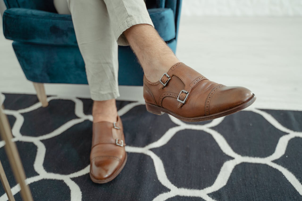 gallery-1 Close-up of stylish brown leather shoes with double buckles, perfect for modern fashion and elegance.