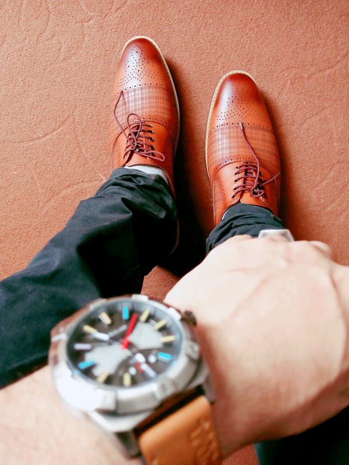 gallery-3 High angle view of brown leather shoes and wristwatch, perfect for showcasing men's fashion elegance.